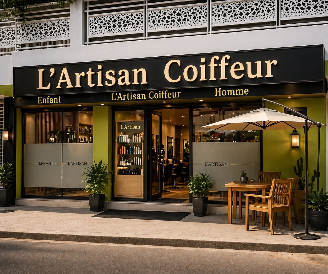LArtisan Coiffeur hair salon storefront with black and white signage, wooden chairs under umbrella seating area, and plants at entrance